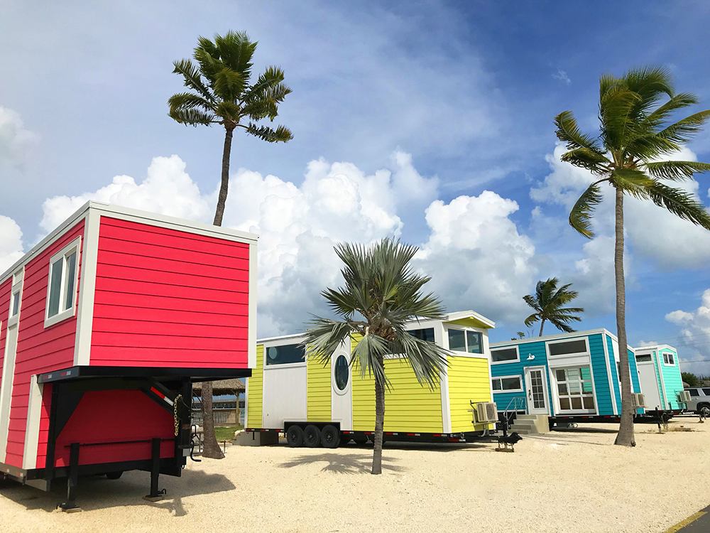 The five new tiny houses that make up Petite Retreats Sunshine Key Tiny House Village, aptly named Kai, Pearl, Lucy, Isla, and Hemingway, are each under 350 square feet in size. The colorful tiny house village resides on the shore of the 75-acre island of Sunshine Key RV Resort and Marina near Big Pine Key.