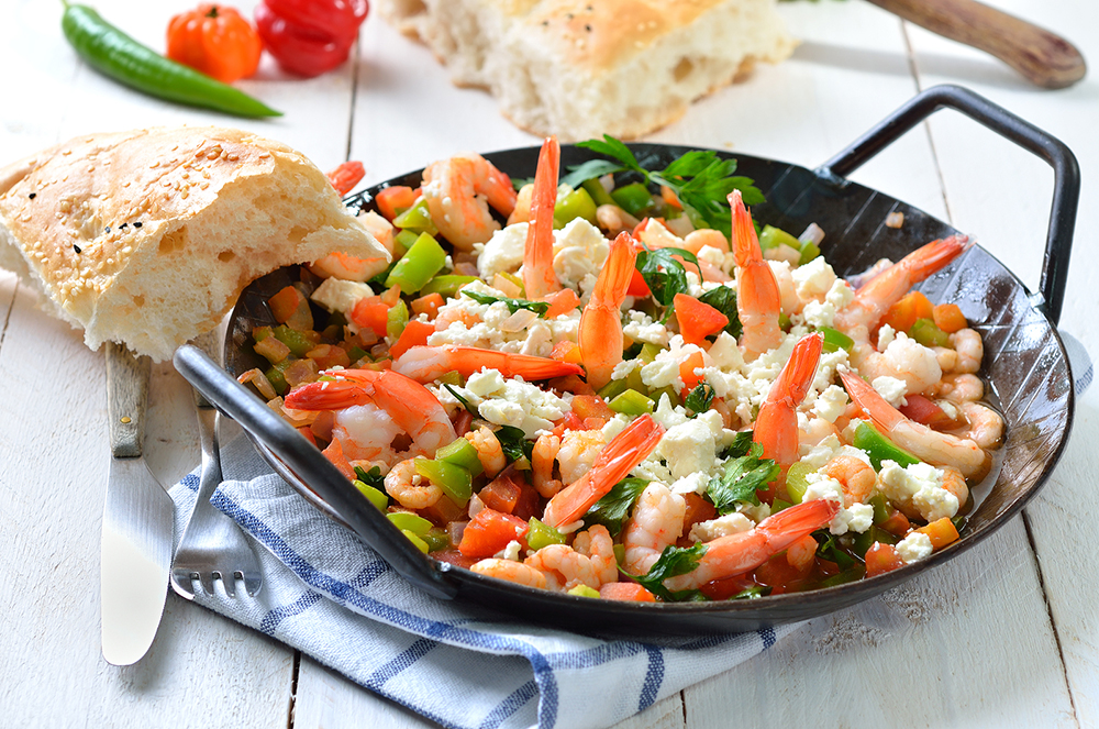 Greek food: Saganaki with shrimps, vegetables and feta cheese