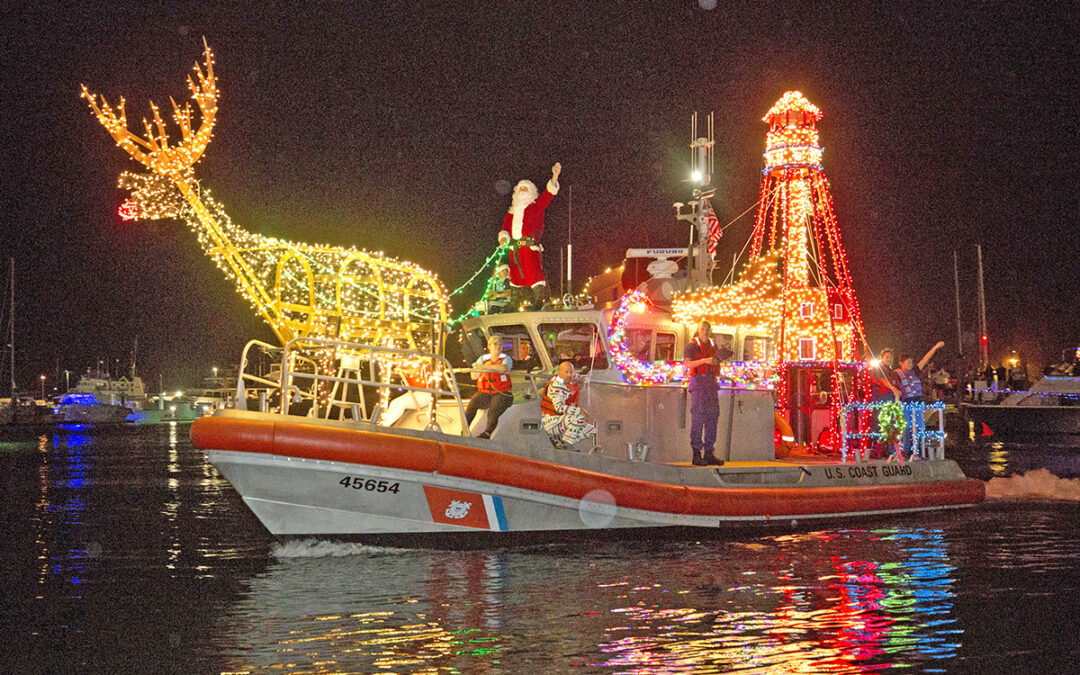 Rudolph the Red Nosed Reindeer and Santa Claus guide an American Shoal Lighthouse themed U.S. Coast Guard boat and crew through the Key West Historic Seaport harbor Saturday evening during the Schooner Wharf Bar/Absolute Vodka Lighted Boat Parade. Hundreds of spectators lined the pier for the dazzling display of maritime holiday cheer, one of multiple events taking place during the annual Key West Holiday Fest, which is presented in part by the Lodging Association of the Florida Keys & Key West and the Monroe County Tourist Development Council and continues island-wide through December 31. (Photo: Carol Tedesco/KeyWestHolidayFest.com)