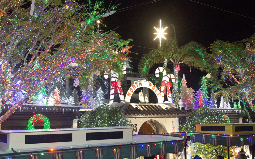 Conch Train Holiday Lights Tour revelers enjoy the prize-winning “North Pole” spectacle at 503 Washington Street Friday night. The tours, which concluded on Friday, are among many island-wide Key West Holiday Fest events that kicked off in November and continue through December 31 with an array of festive choices for ringing in the New Year. For more information on Holiday Fest happenings, contact the Lodging Association at 305-296-4959 or visit keywestholidayfest.com. (Photo Carol Tedesco/KeyWestHolidayFest.com)