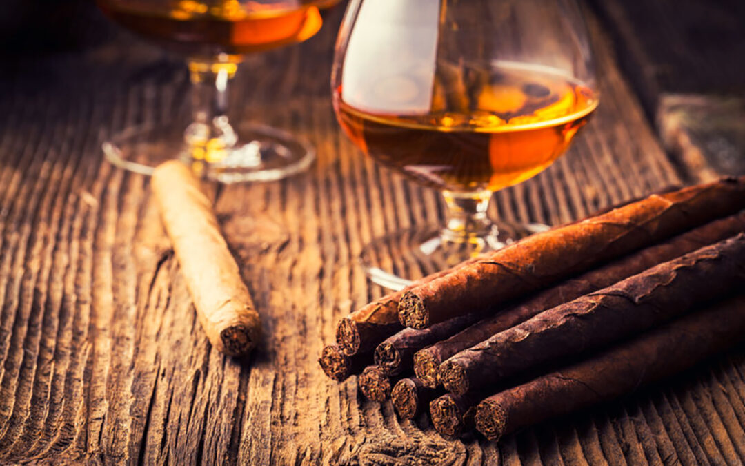 quality cigars and cognac on an old wooden table