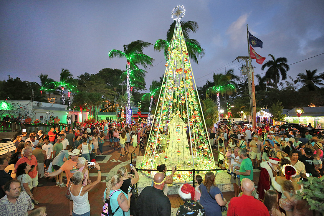 Holiday revelers surround a fishing buoy themed Christmas tree as it is illuminated for the first time of the season during Wednesday evening’s official lighting of the Key West Historic Seaport ‘Harbor Walk of Lights.’ The ceremonial Thanksgiving Eve lighting of the Seaport’s many trees, ships, shops, restaurants and watering holes marks the beginning of Key West Holiday Fest, an annual island-wide celebration of the holidays presented in part by the Lodging Association of the Florida Keys and Key West and the Monroe Country Tourist Development Council that continues through December 31. For an extensive event schedule, visit www.KeyWestHolidayFest.com and click on the Calendar of Events tab. (Carol Tedesco / KeyWestHolidayFest.com)
