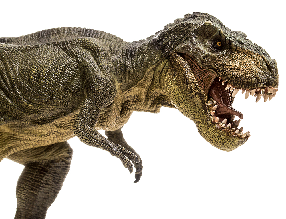 extreme closeup view of an ominous T-Rex dinosaur figurine
